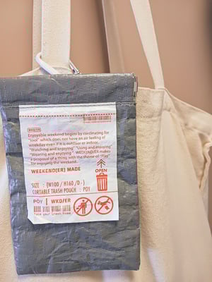 トートバッグの持ち手に取り付けられたゴミ箱ポーチの写真